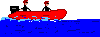 rotes motorisiertes Schlauchboot in voller Fahrt